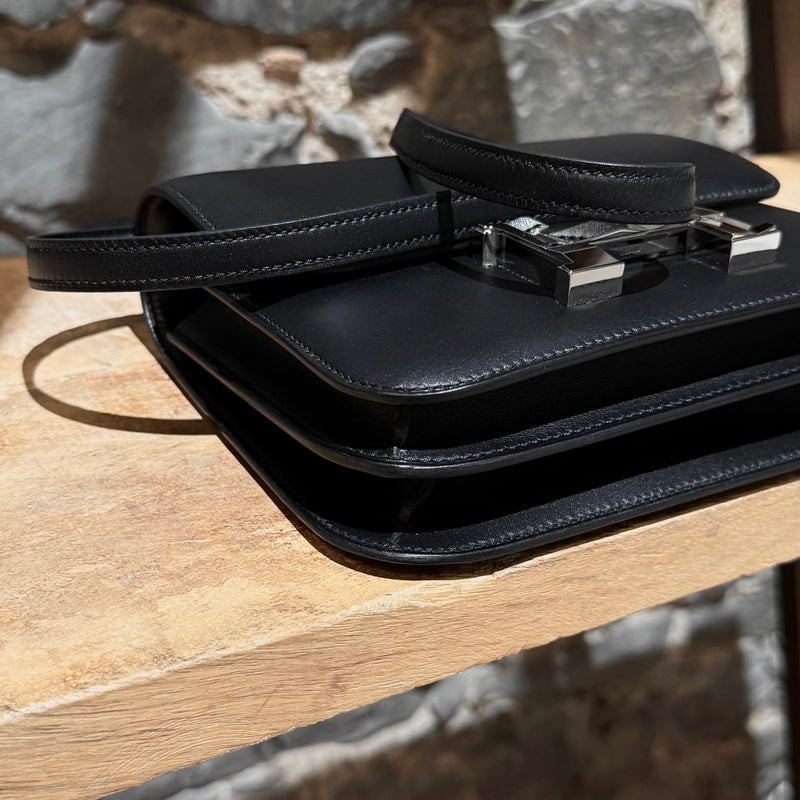 Bottom corners of Hermès 2021 Limited Edition Black Monsieur Studio Disco Mini Constance III 18 Bag