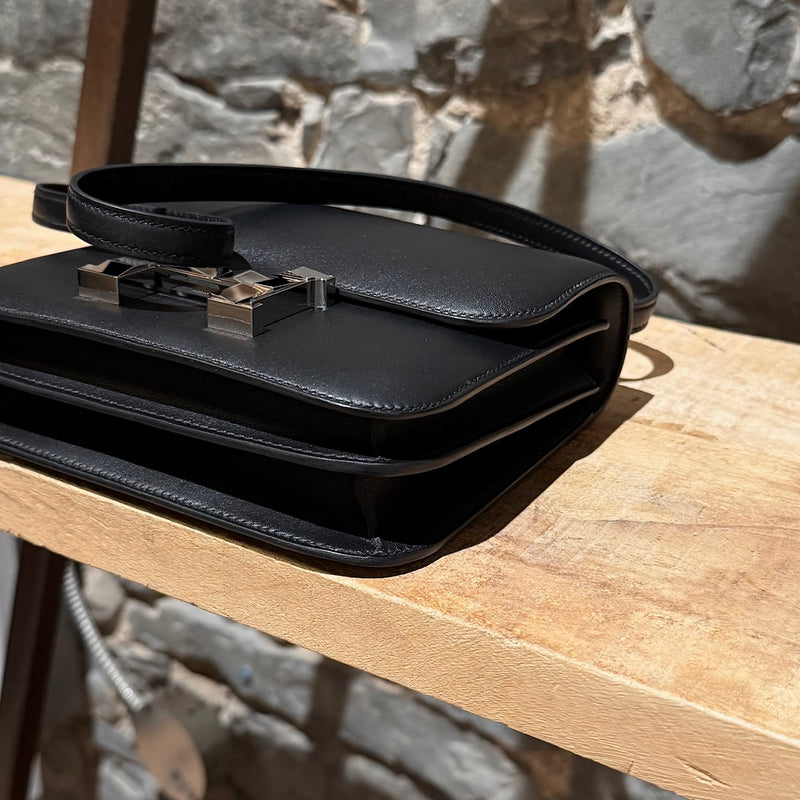 Bottom corners of Hermès 2021 Limited Edition Black Monsieur Studio Disco Mini Constance III 18 Bag