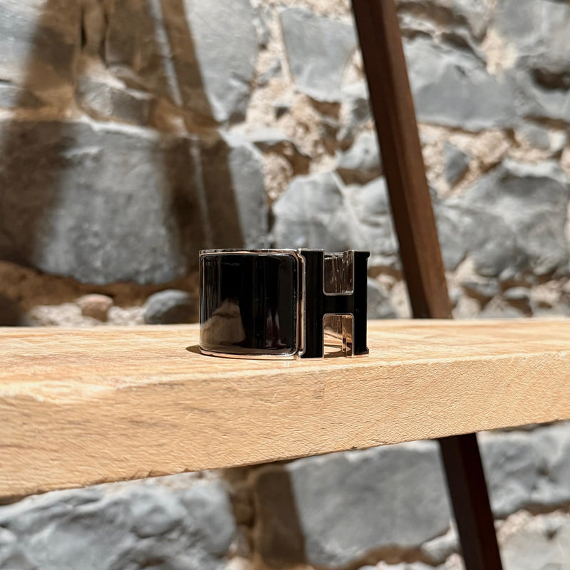 Side front view of Hermès Black Enamel Extra Wide Clic Clac H PHW Bracelet