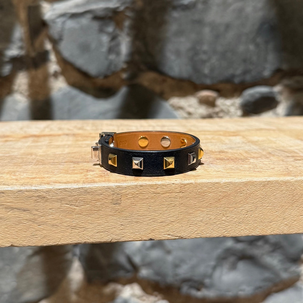 A side view of Hermès Black Leather Mini Dog Gold Platinum Studded Bracelet