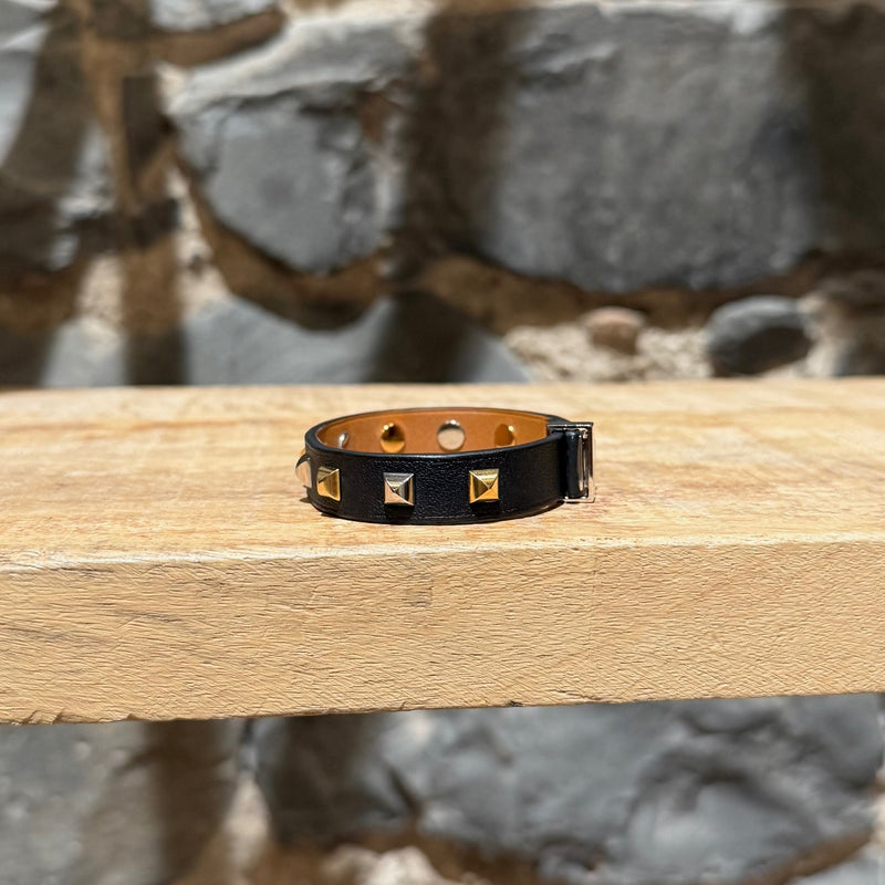 A side view of Hermès Black Leather Mini Dog Gold Platinum Studded Bracelet