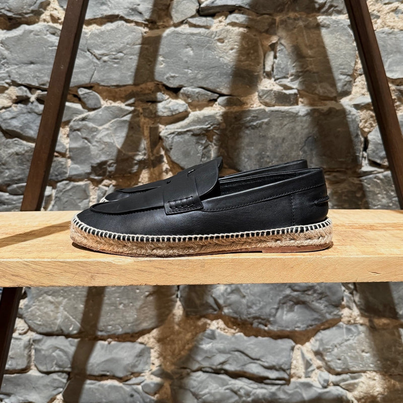 A side view of Hermès Black Leather Trip H Mocassin Espadrilles