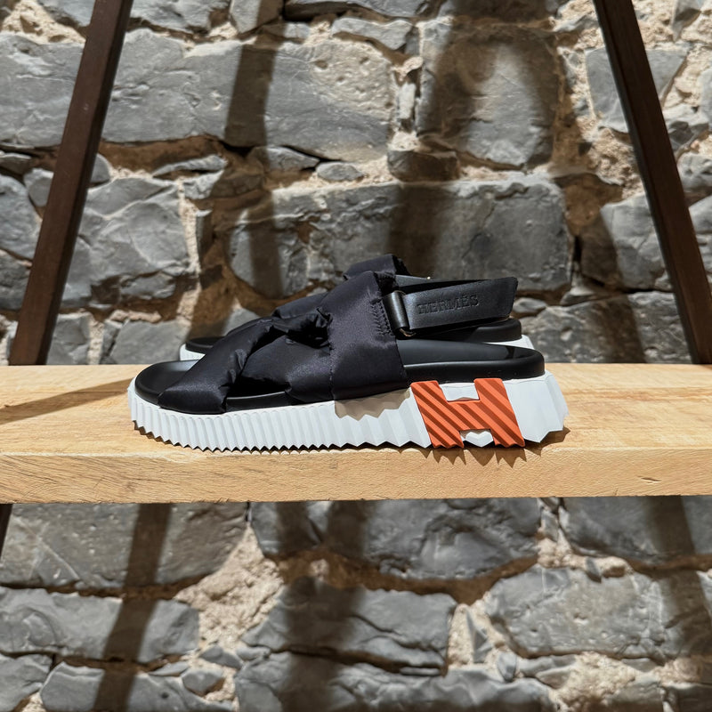 A side view of Hermès Black Nylon Electric Criss Cross Sandals