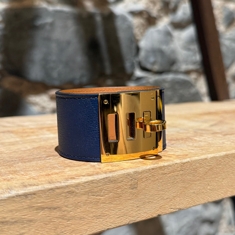 Side front view of Hermès Blue Saphir Swift Leather Gold Plated Kelly Dog Bracelet