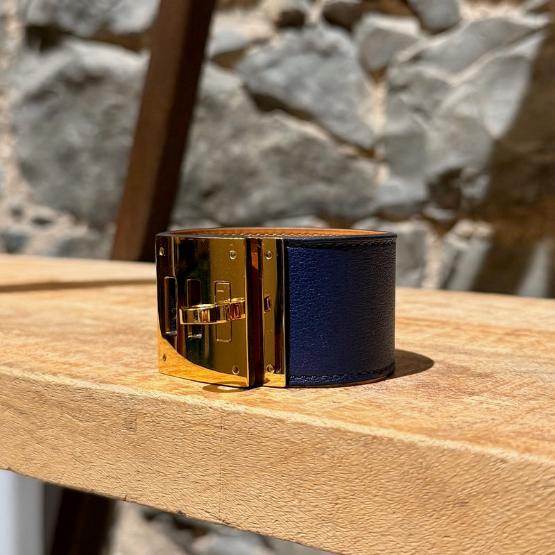 Side front view of Hermès Blue Saphir Swift Leather Gold Plated Kelly Dog Bracelet