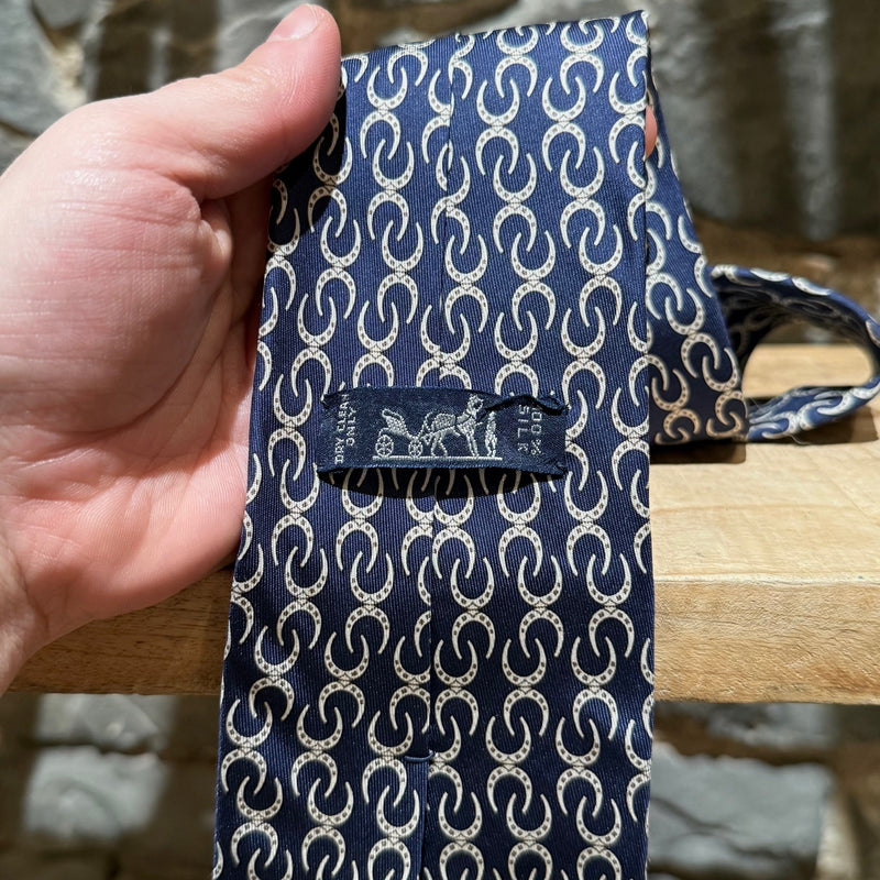 Brand detail of Hermès Horseshoe Prints Navy Silk Tie