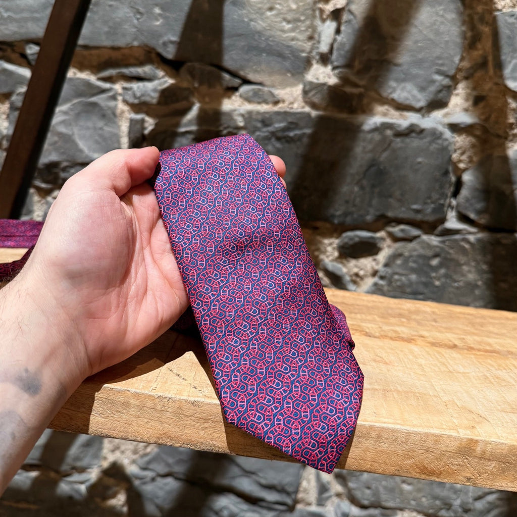 Close up of Hermès Pink Chaine D'Ancre Pattern Navy Silk Tie