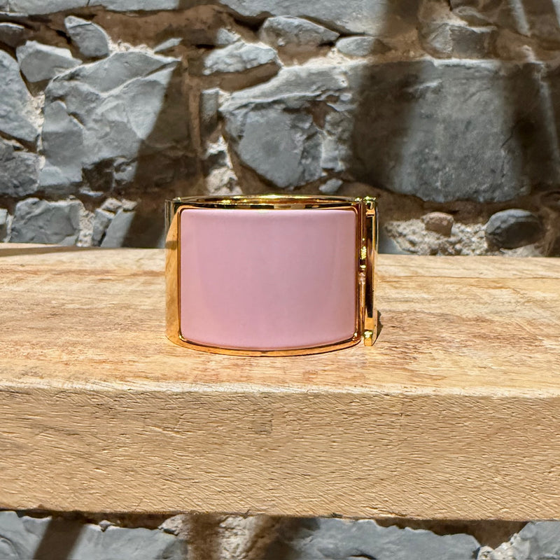 A side view of Hermès Pink Enamel Extra Wide Clic Clac H Gold Plated Bracelet