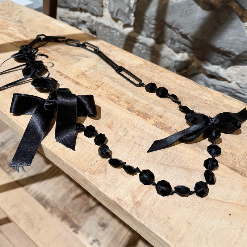 faceted black stones, satin ribbon details, and oversized chain links of Lanvin Black Stone Satin Bow Chain Link Necklace