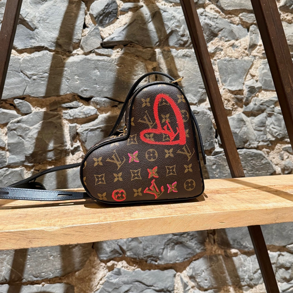 A side view of Louis Vuitton 2021 Fall In Love Sac Coeur Monogram Bag