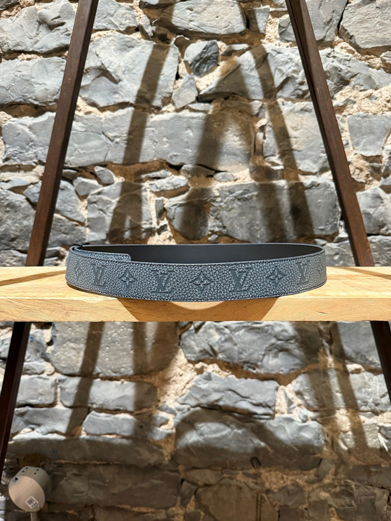 A Grey side view of Louis Vuitton 2022 Grey Taurillon Monogram Flower LV Shape Reversible Belt