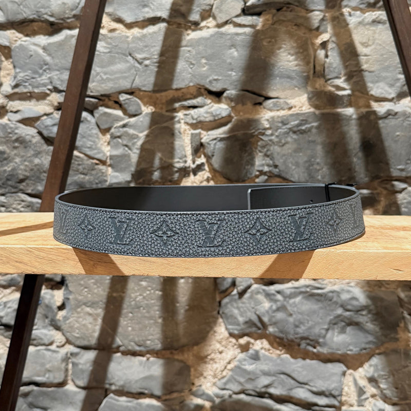 A grey side view of Louis Vuitton 2022 Grey Taurillon Monogram Flower LV Shape Reversible Belt