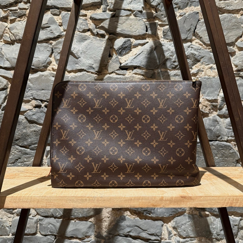 A side view of Louis Vuitton Etui Voyage Brown Monogram GM Pouch