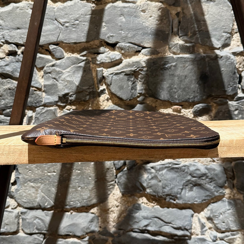 A side view of Louis Vuitton Etui Voyage Brown Monogram GM Pouch