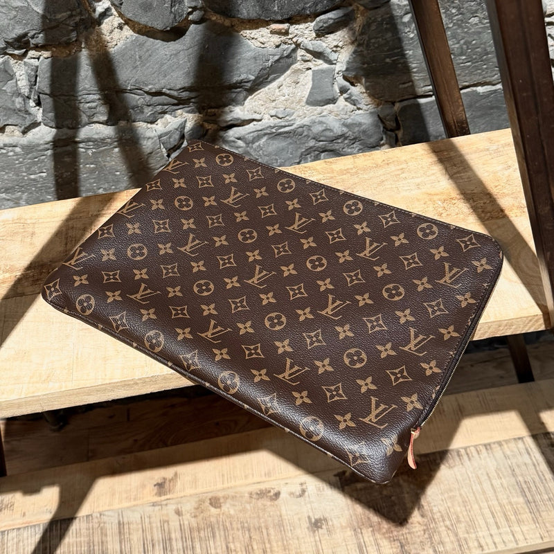 A side view of Louis Vuitton Etui Voyage Brown Monogram GM Pouch
