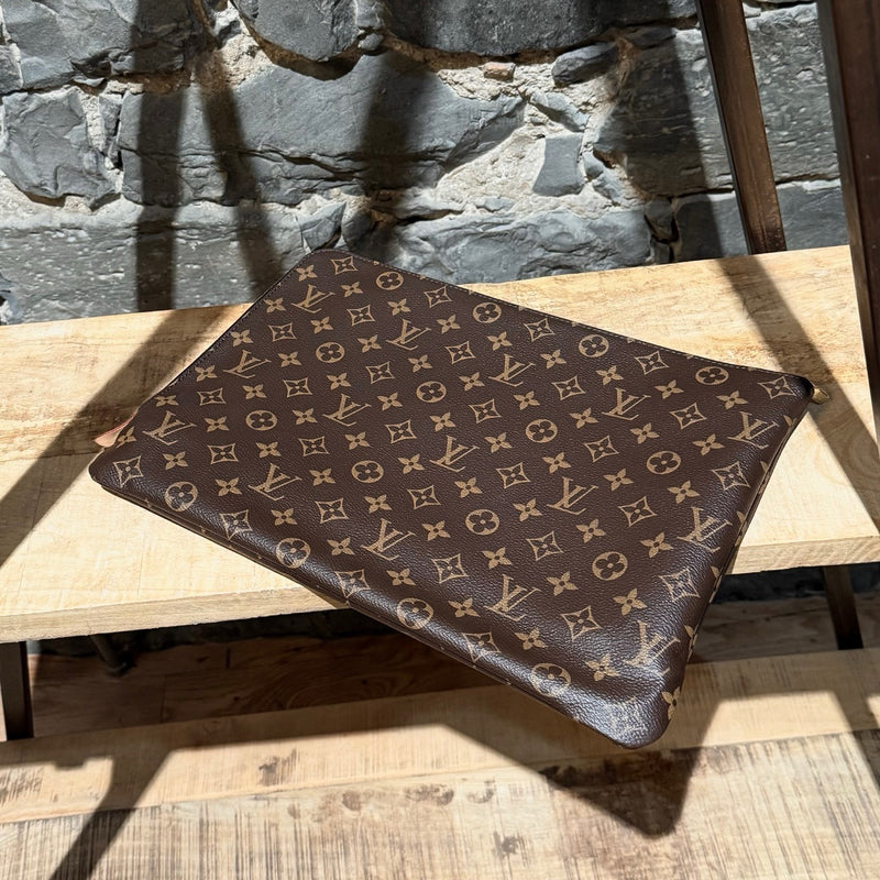 A side view of Louis Vuitton Etui Voyage Brown Monogram GM Pouch