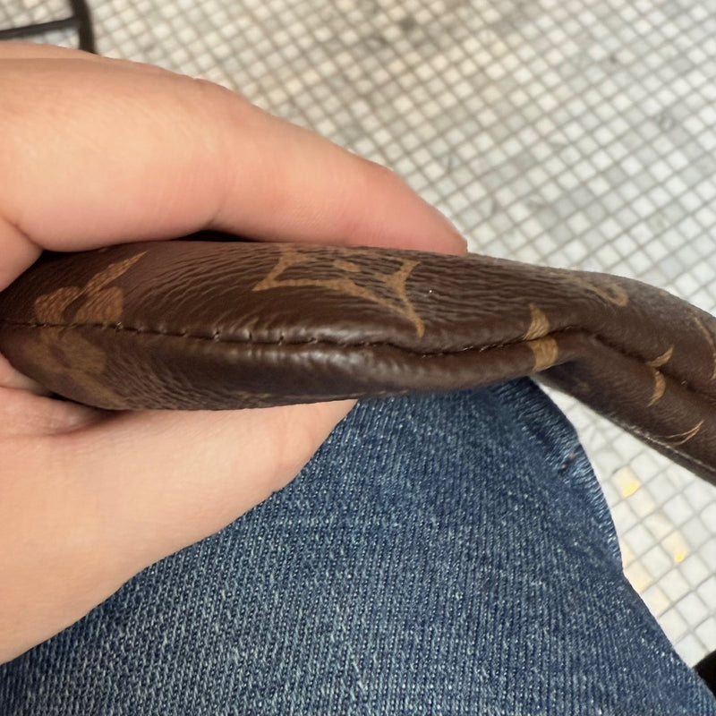 A corner of Louis Vuitton Etui Voyage Brown Monogram GM Pouch