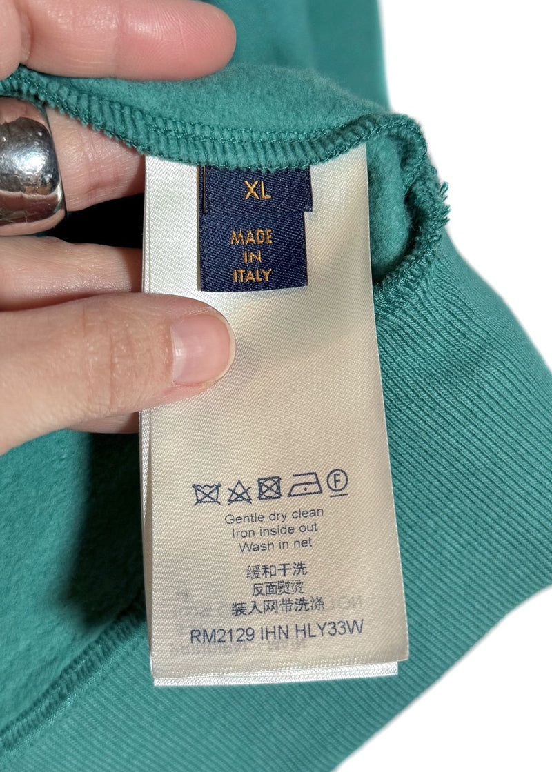 Size and care label of Louis Vuitton FW21 Teal Green Pin Logo Embroidered Hoodie