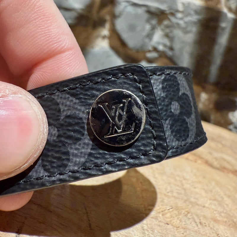 Close-up on branded snap closure of Louis Vuitton Hockenheim Eclipse Monogram Bracelet