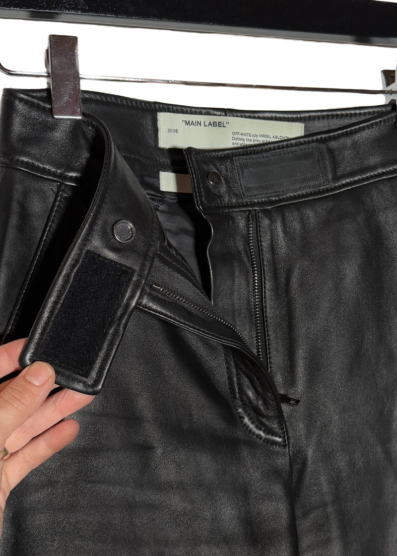 Velcro strap waistband closure with a snap-button and zipper fly of Off-White Black Leather Tied Ankle Pants