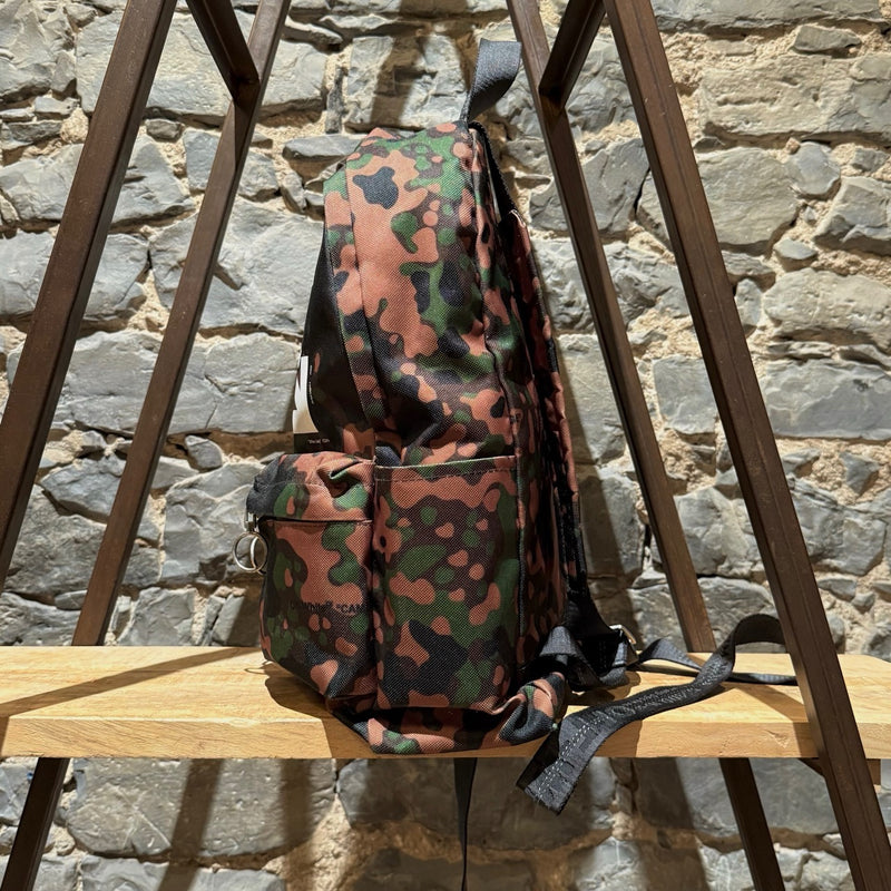 A side view of Off-white Green Camouflage Arrow Print Backpack