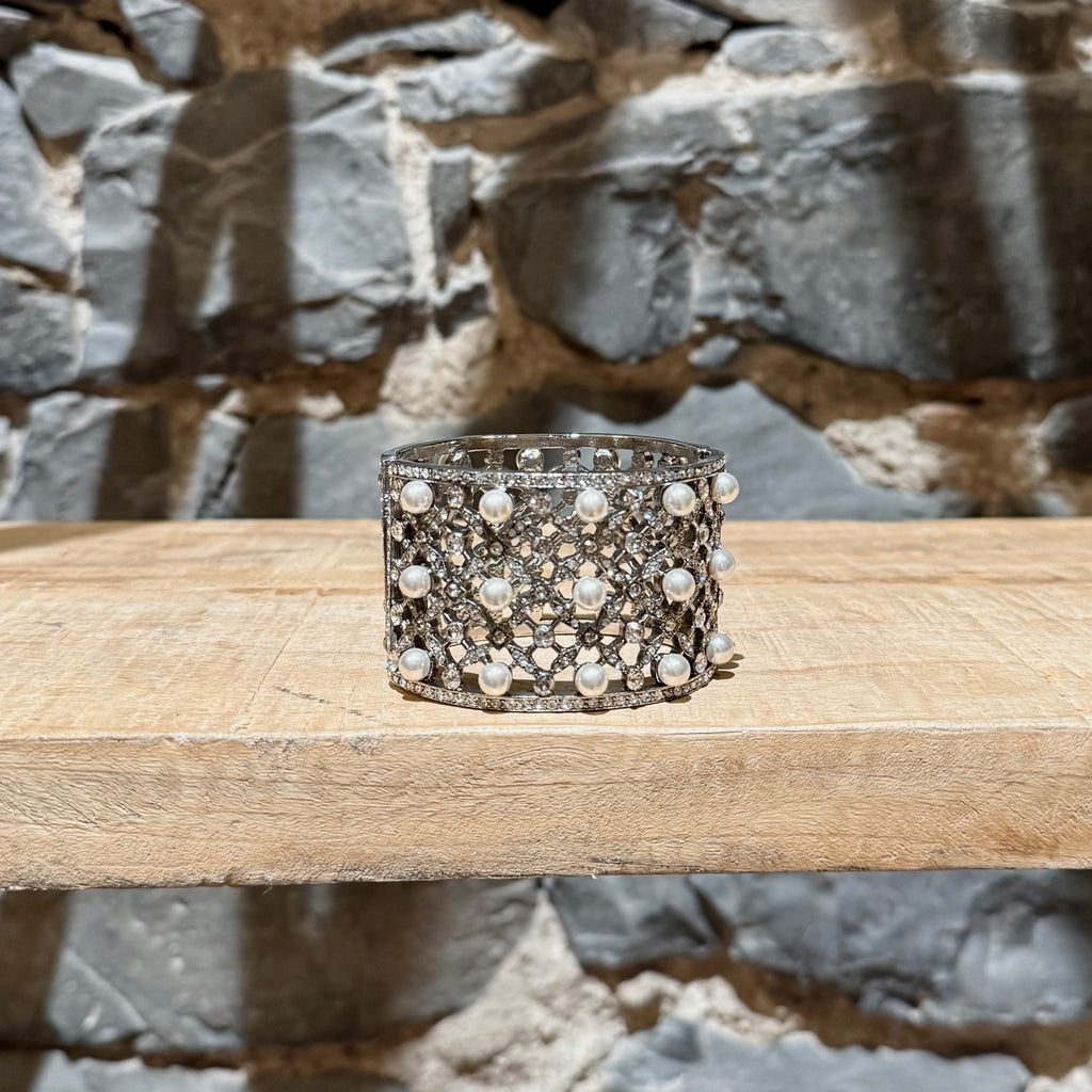 A side of Oscar De La Renta Crystal Pearl Embellished Hinged Cuff Bracelet