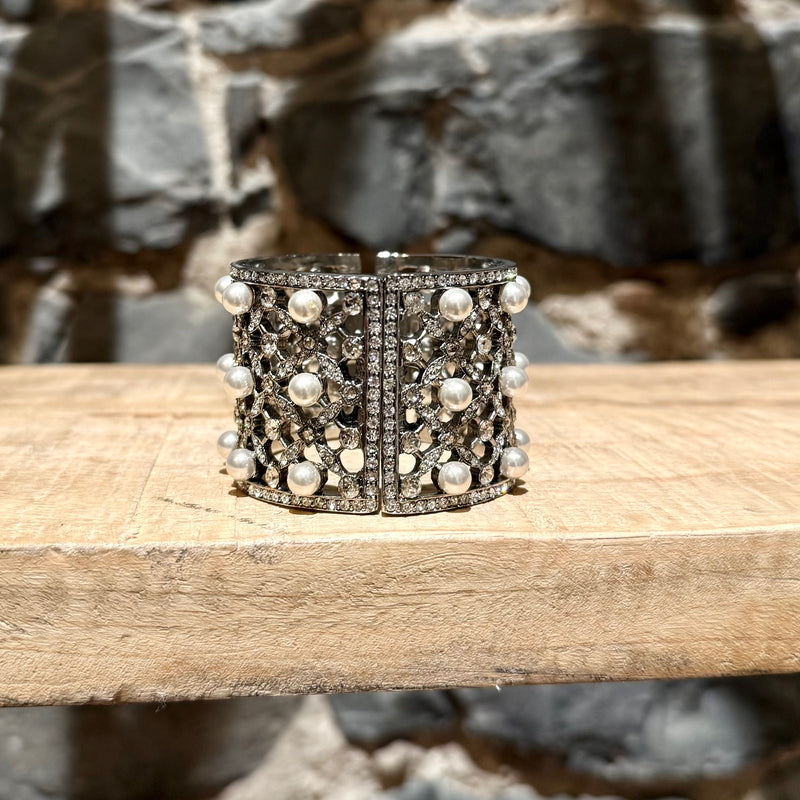 A side of Oscar De La Renta Crystal Pearl Embellished Hinged Cuff Bracelet