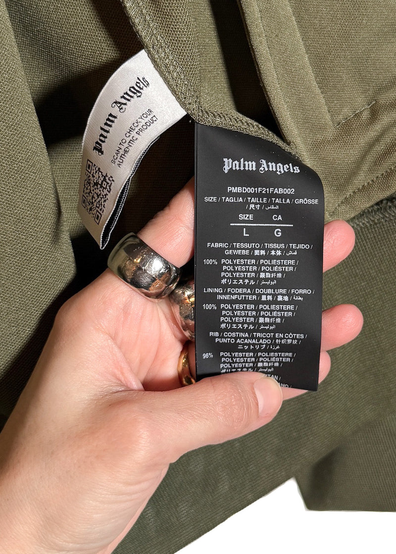 Size and material label of Palm Angels Khaki Green Logo Track Sweater