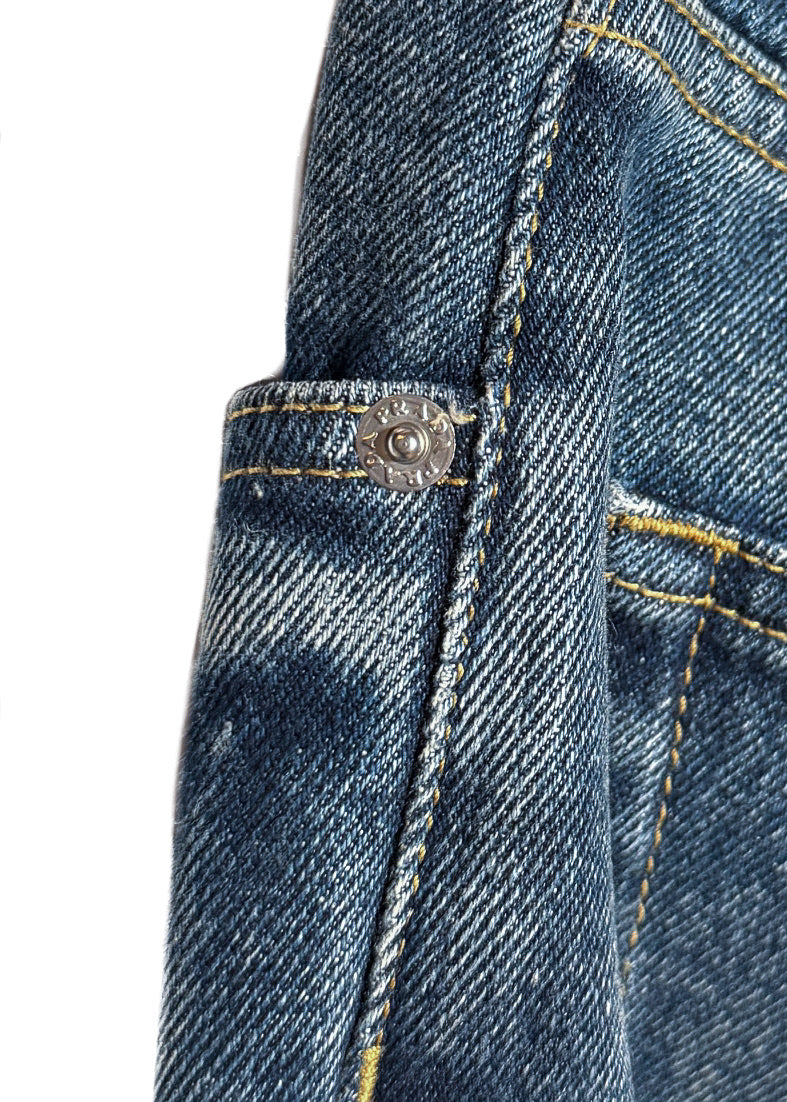 Close-up on rivet, engraved branded silver-tone metal button, yellow contrast stitching of Prada 2021 Washed Blue Triangle Logo Straight Leg Jeans