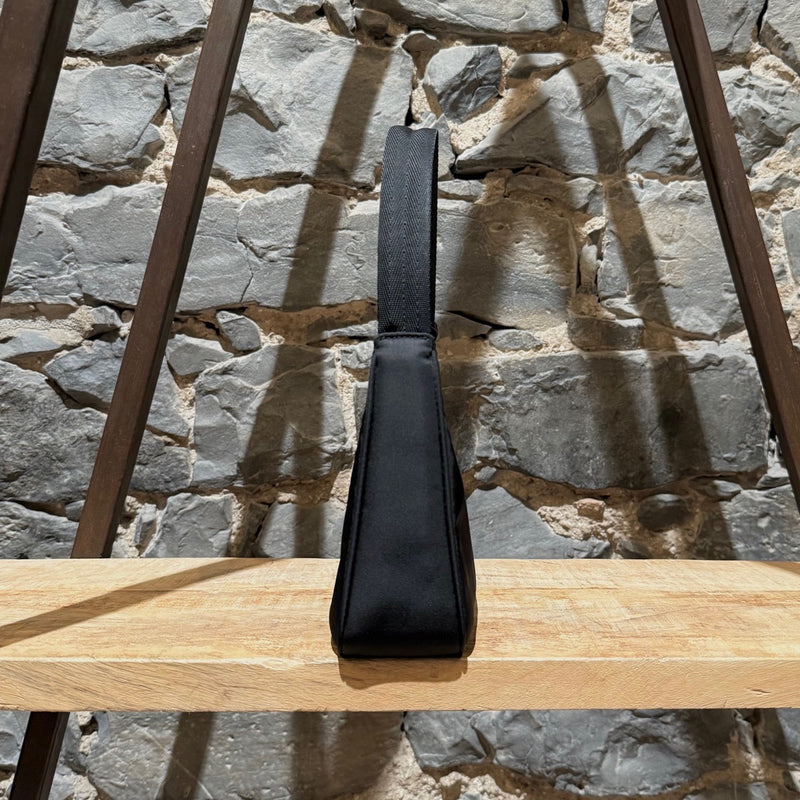 A side view of Prada Black Tessuto Nylon Re-Edition 2000 Bag