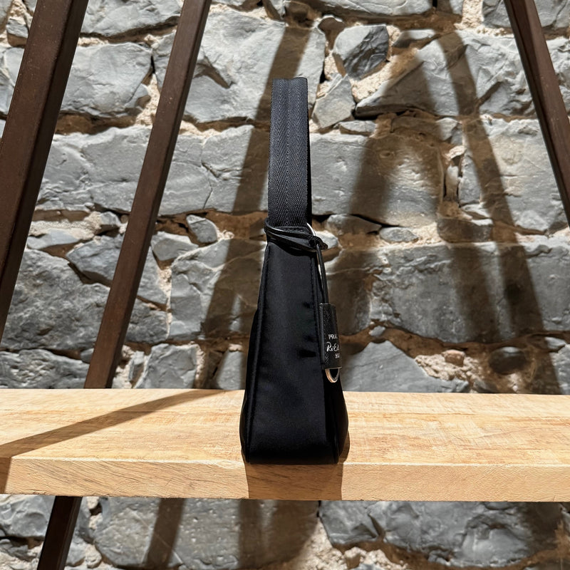 A side view of Prada Black Tessuto Nylon Re-Edition 2000 Bag