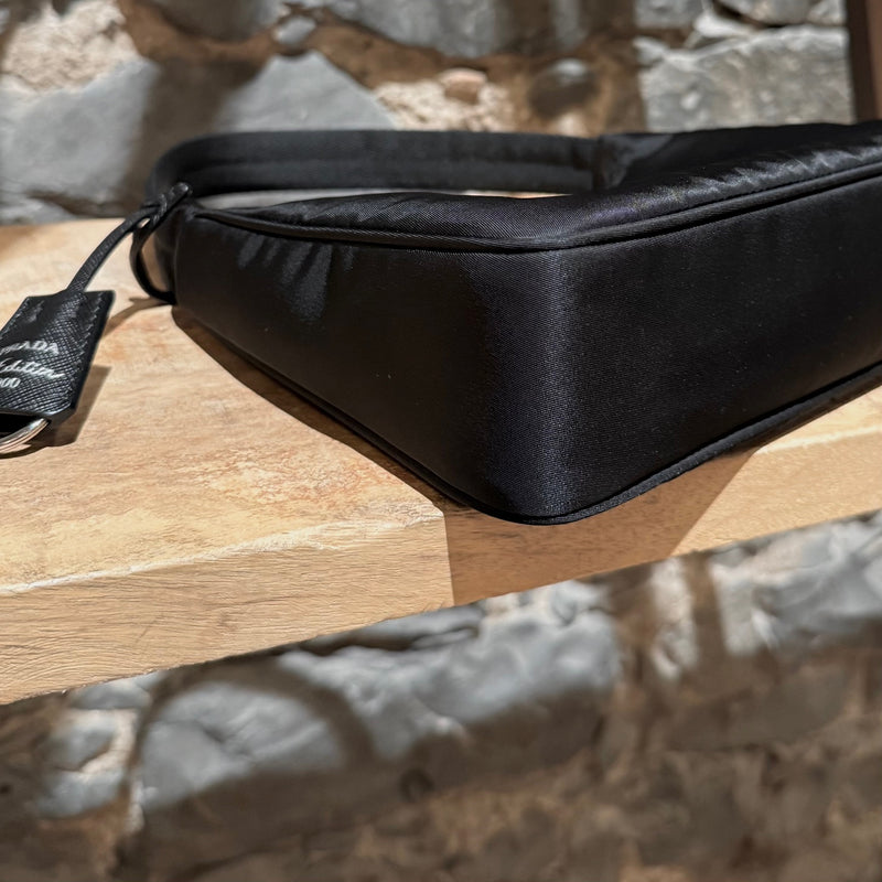 A bottom corner of Prada Black Tessuto Nylon Re-Edition 2000 Bag