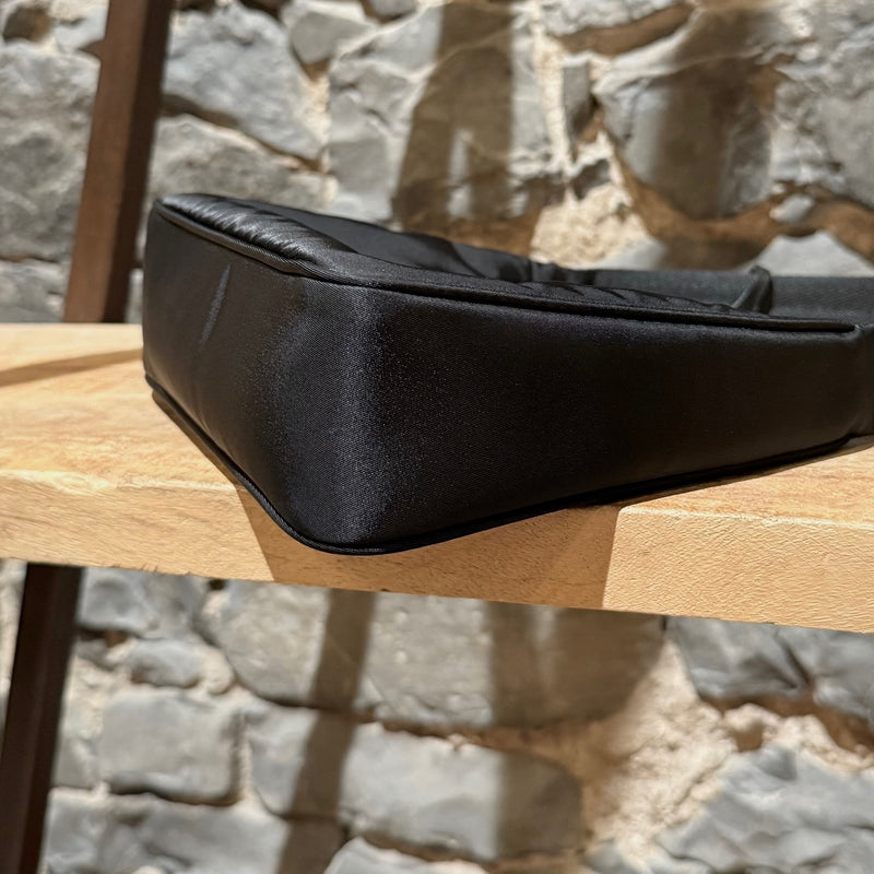 A bottom corner of Prada Black Tessuto Nylon Re-Edition 2000 Bag