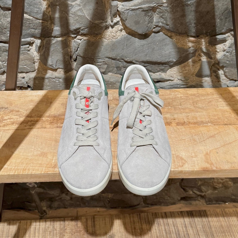 Prada Linea Rossa light grey suede low-top sneakers with green accents, showing details, wear, and branding.