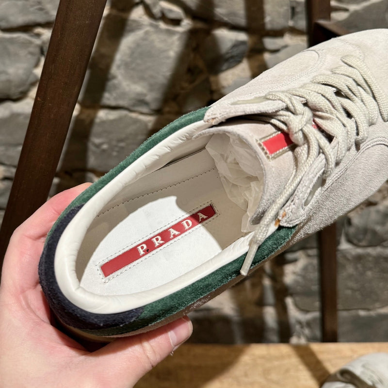 Prada Linea Rossa light grey suede low-top sneakers with green accents, showing details, wear, and branding.