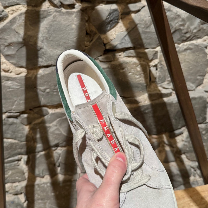 Prada Linea Rossa light grey suede low-top sneakers with green accents, showing details, wear, and branding.