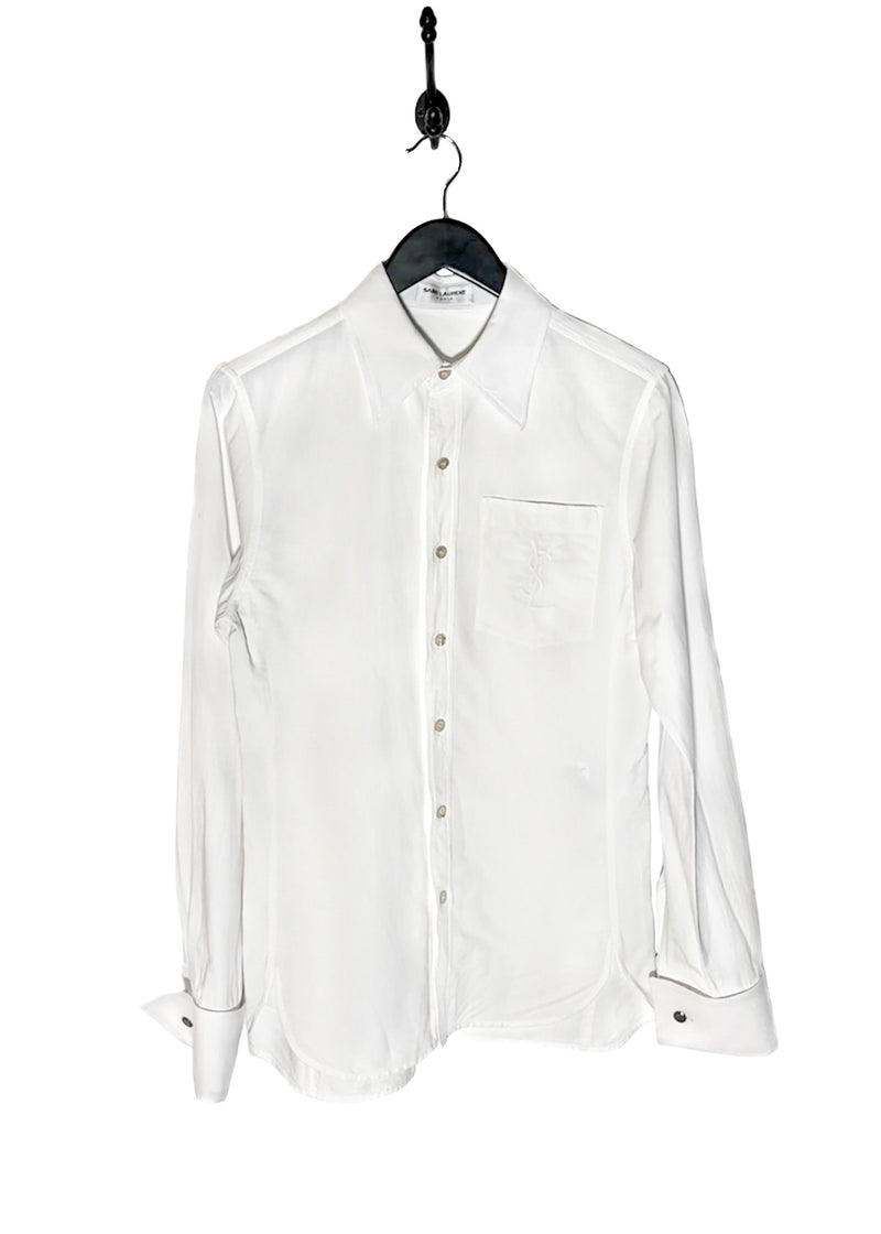 Saint Laurent YSL Logo White Linen Blend Buttoned Shirt. A white button-up shirt featuring a pointed collar, tonal embroidered YSL logo on the chest pocket, and engraved buttoned cuffs. Made in Italy, crafted from a linen-cotton blend, with a clean and lightweight silhouette.