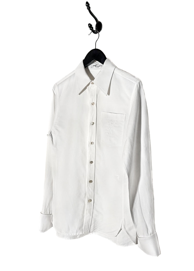 Saint Laurent YSL Logo White Linen Blend Buttoned Shirt. A white button-up shirt featuring a pointed collar, tonal embroidered YSL logo on the chest pocket, and engraved buttoned cuffs. Made in Italy, crafted from a linen-cotton blend, with a clean and lightweight silhouette.