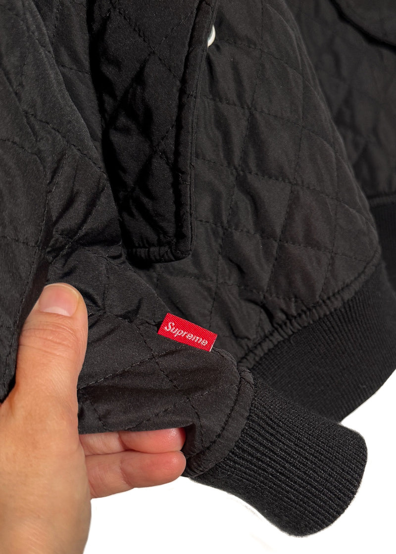 Brand logo flag tab on one cuff of Supreme Automobili Lamborghini Black Quilted Hooded Jacket