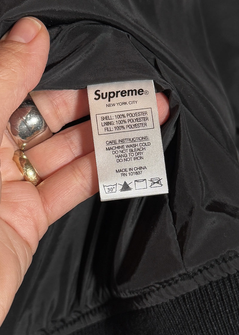 Material and care label of Supreme Automobili Lamborghini Black Quilted Hooded Jacket