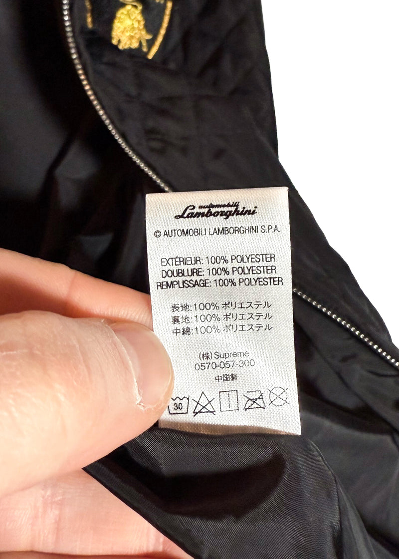 Material and care label of Supreme Automobili Lamborghini Black Quilted Hooded Jacket