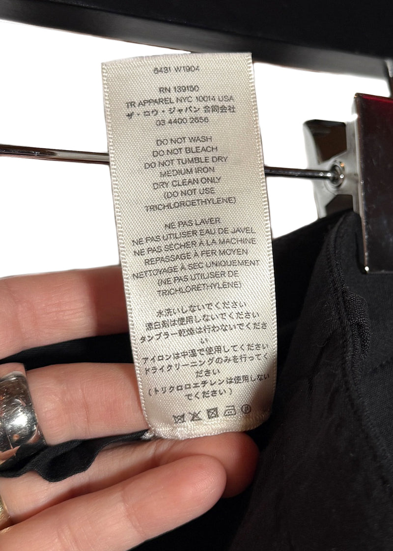 Material and care label of The Row Black Cassandro Satin Cuffed Wide Leg Pants