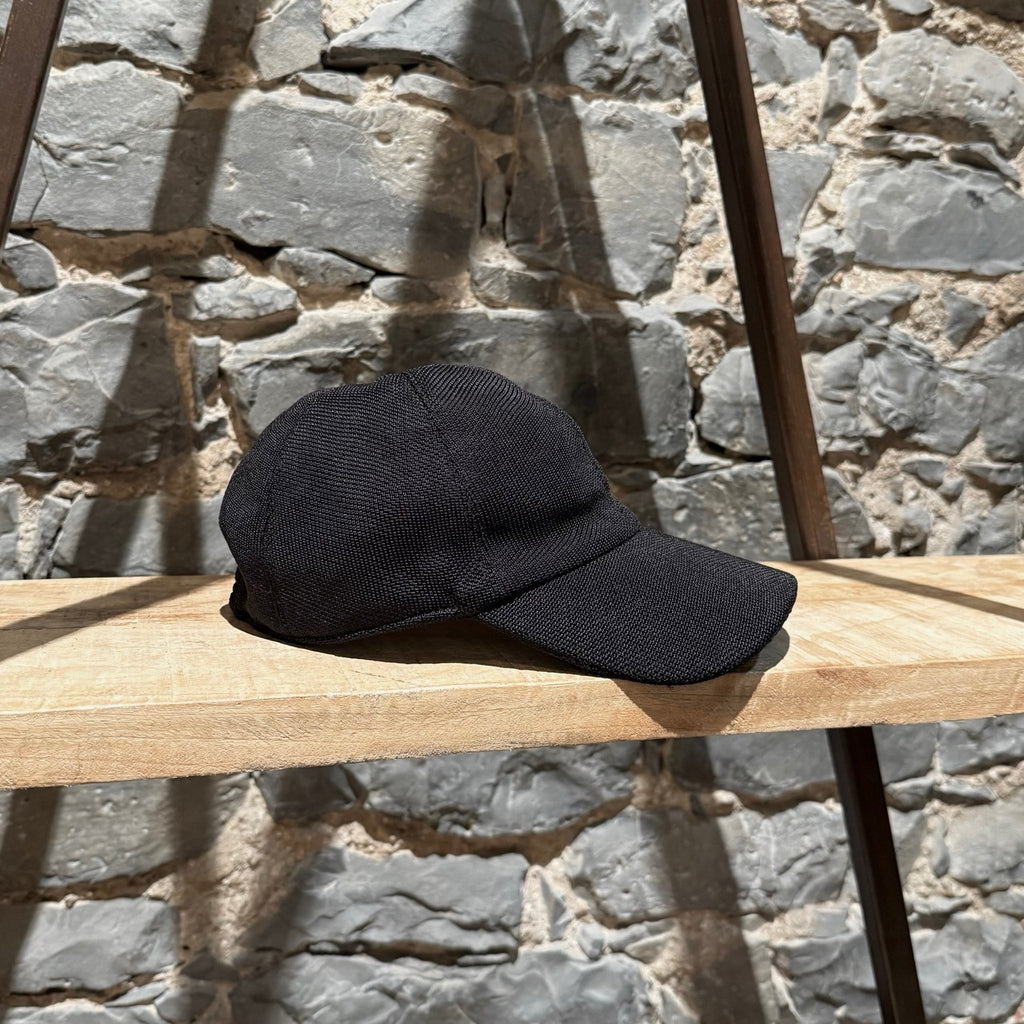 Main photo of The Row Black Silk Knit Caspian Baseball Cap