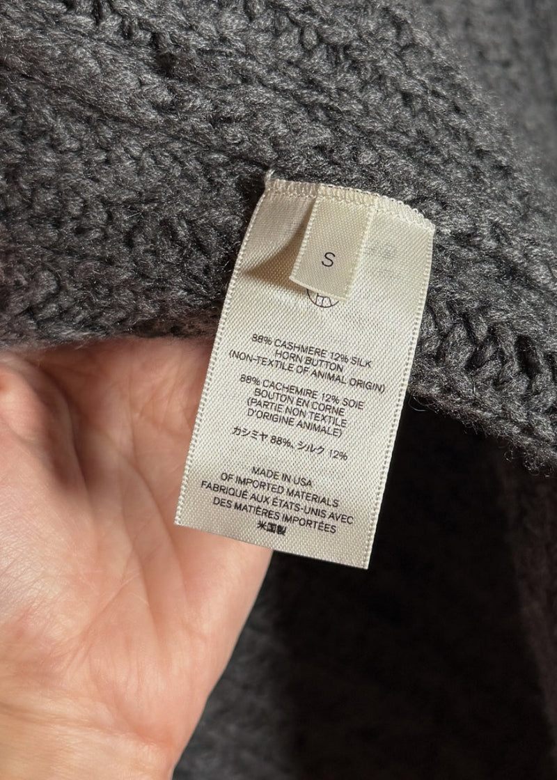 Size and material labels of The Row Grey Chunky Knit Cashmere Silk Data Cardigan Sweater