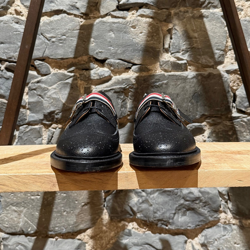Front view of Thom Browne Black Pebbled Grosgrain Tricolour Strap Long Wingtip Shoes