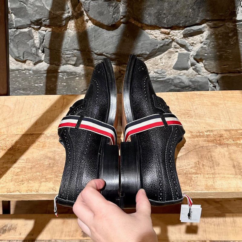 Side-by-side view of Thom Browne Black Pebbled Grosgrain Tricolour Strap Long Wingtip Shoes