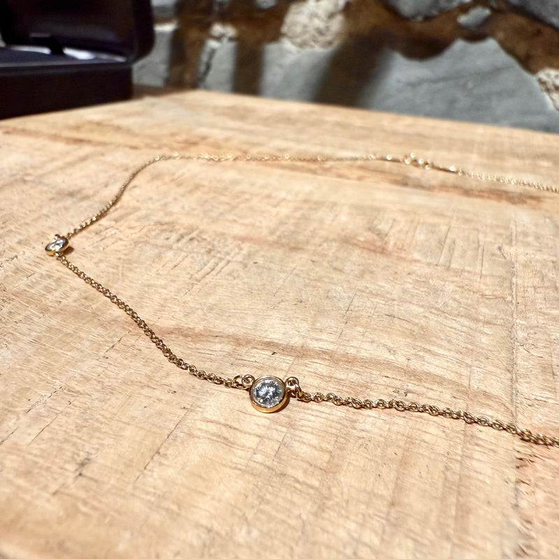 A close-up of a diamond station on the necklace, showing its precise bezel-set craftsmanship.