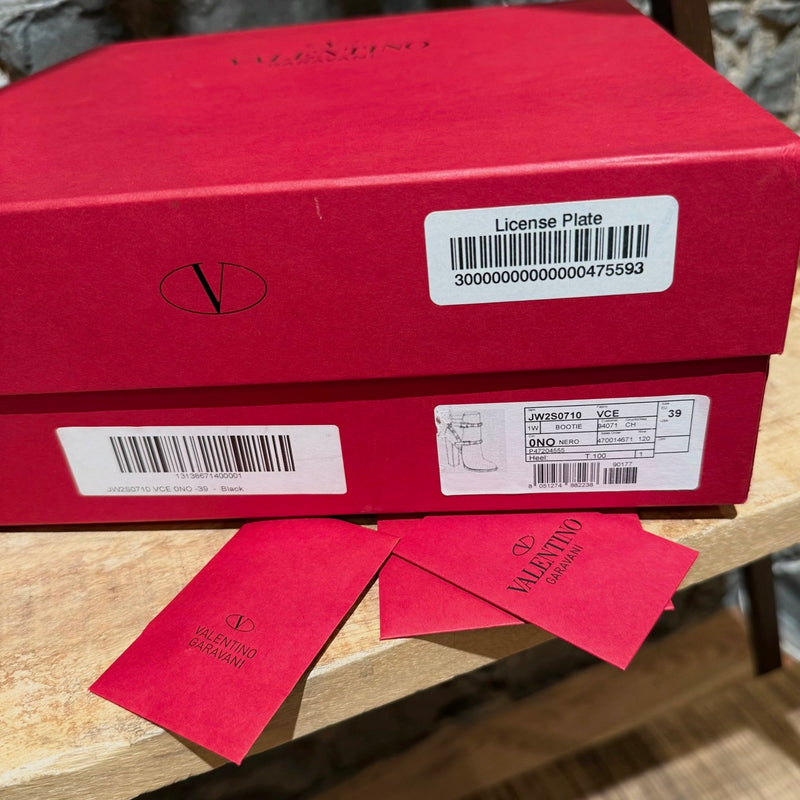 Packaging of Valentino Black Grained  Leather Rockstud Heeled Ankle Boots