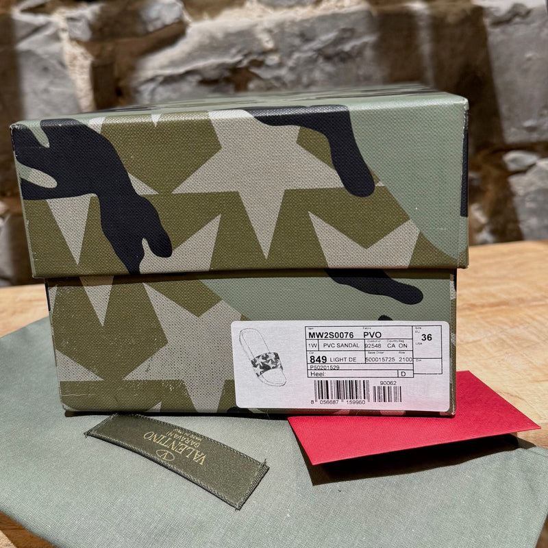 packaging and dustbag of Valentino Blue Camo Star Rubber Slides