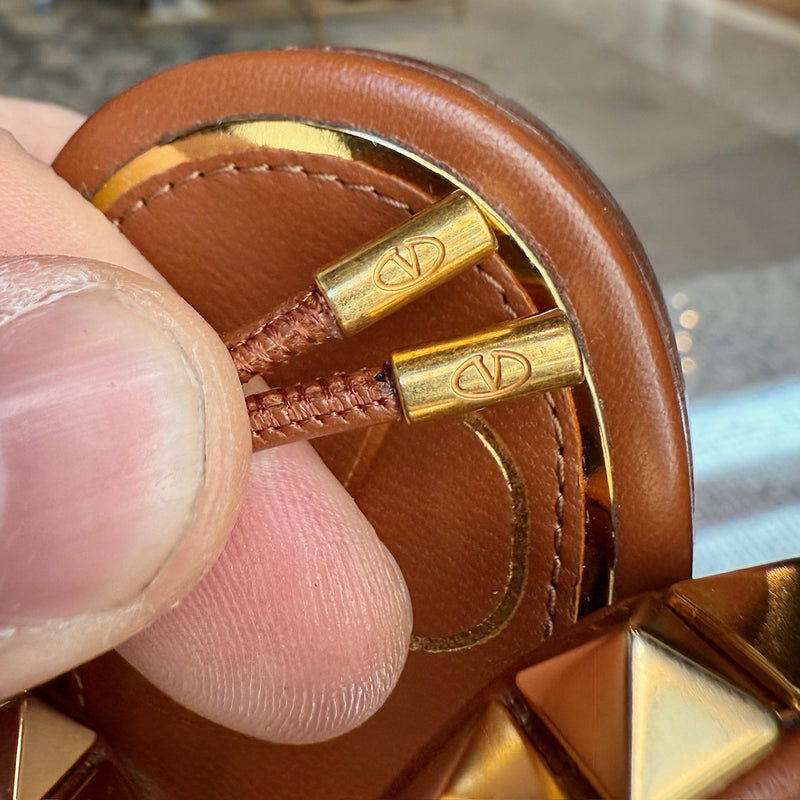 Brand detail on Valentino Brown Leather Gold Studded No Limit Gladiator Flat Sandals